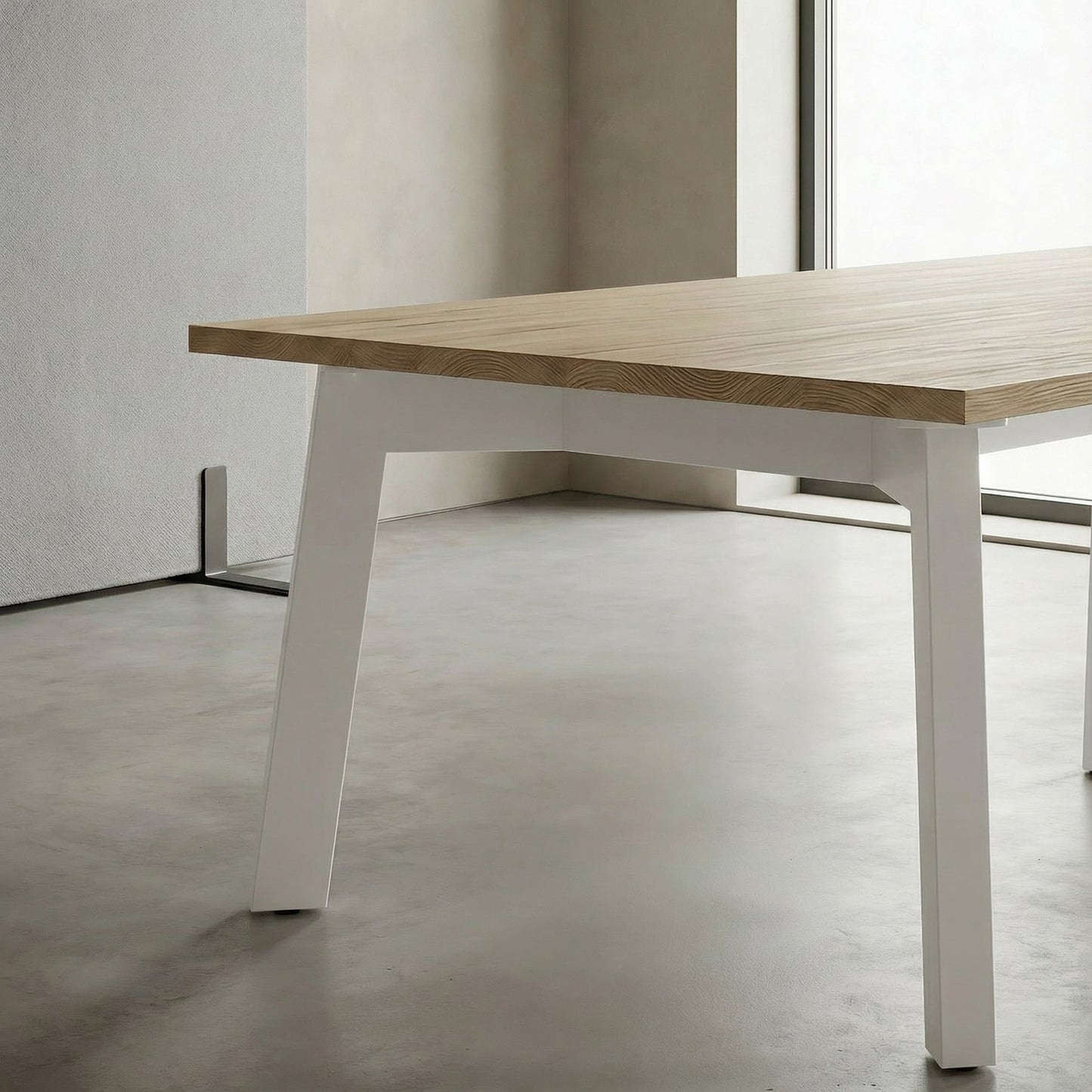 Wooden boardroom table with white legs in a minimalistic room