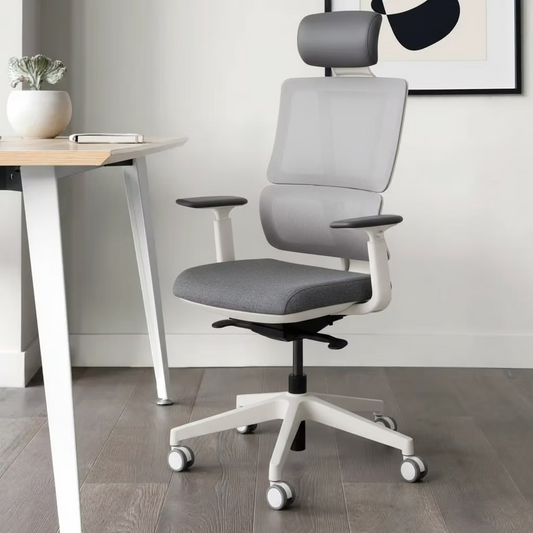 Gray office chair with white base in a room with a desk and plant.