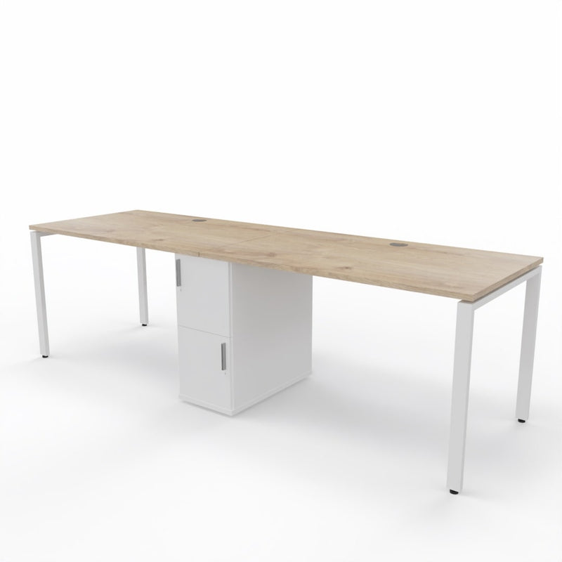 2 person steel frame workstation desk with a shared storage in die middle, oak table top, white storage unit and white steel frame legs on a white background. 