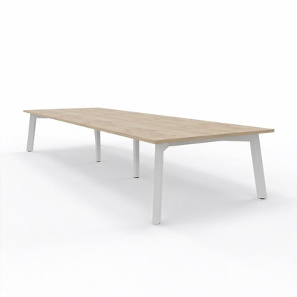 Large XXL Boardroom table with light brown oak top and 4 legged white steel frame on a light grey background