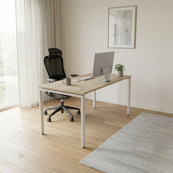 Modern office setup with a desk, chair, and computer in a bright room.