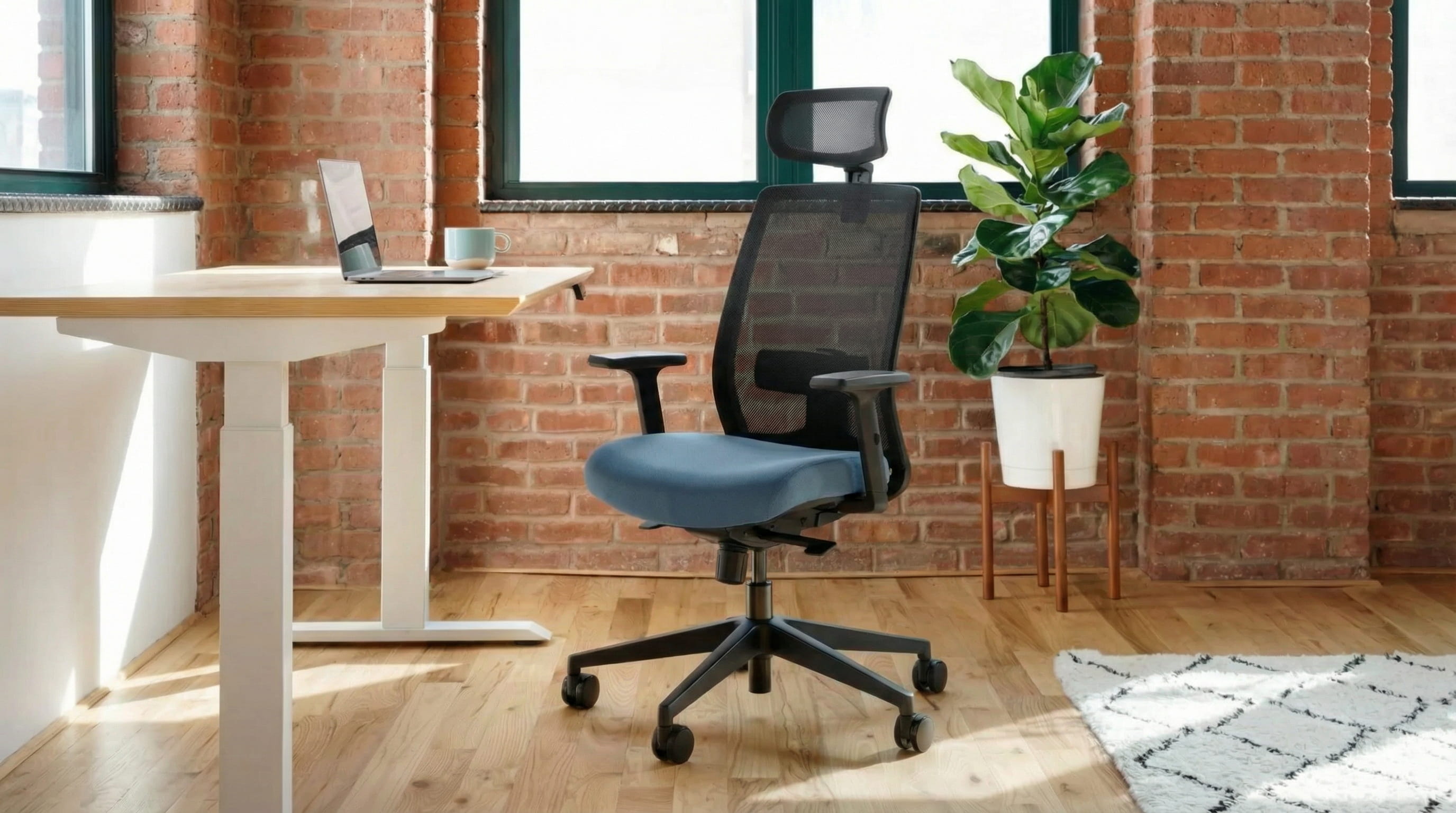 Modern office chair in a bright room with a standing desk and plant.
