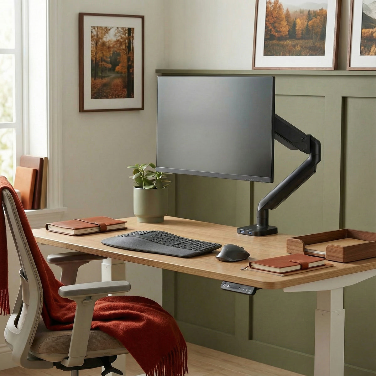 Black monitor arm with other office space accessories in home office