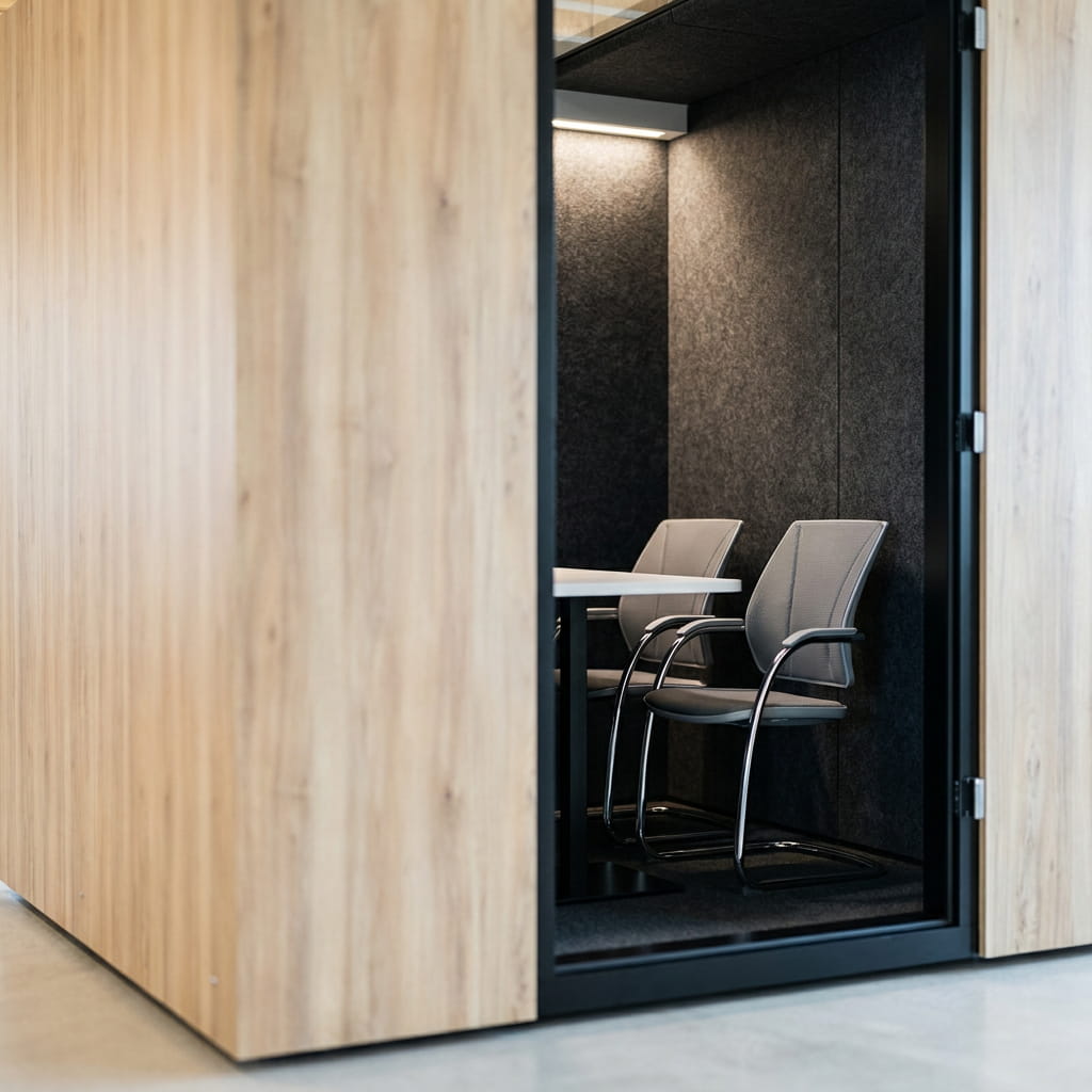 Close-up of the SkyLite 4-seater meeting pod showing the glazing and laminate finish