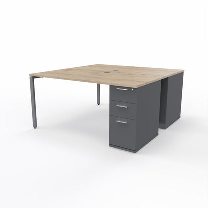 Dual desk workstation for two people with wooden oak table top, two dark grey storage units, and a grey steel frame on a plain white background