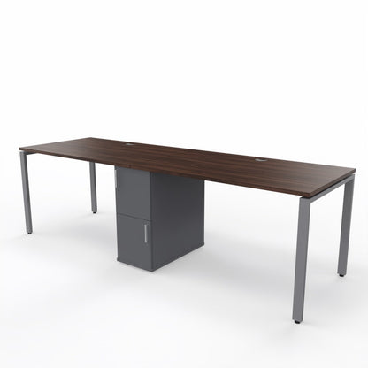 2 person steel frame workstation desk with a shared storage in die middle, brown wooden table top, dark grey storage unit and steel frame legs on a white background. 