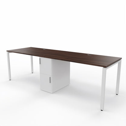 2 person steel frame workstation desk with a shared storage in die middle, dark brown table top, white storage unit and white steel frame legs on a white background. 