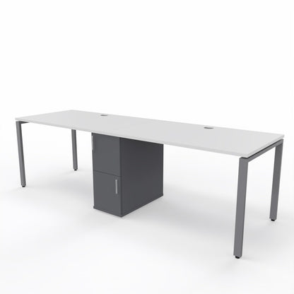2 person steel frame workstation desk with a shared storage in die middle, white table top, dark grey storage unit and steel frame legs on a white background. 
