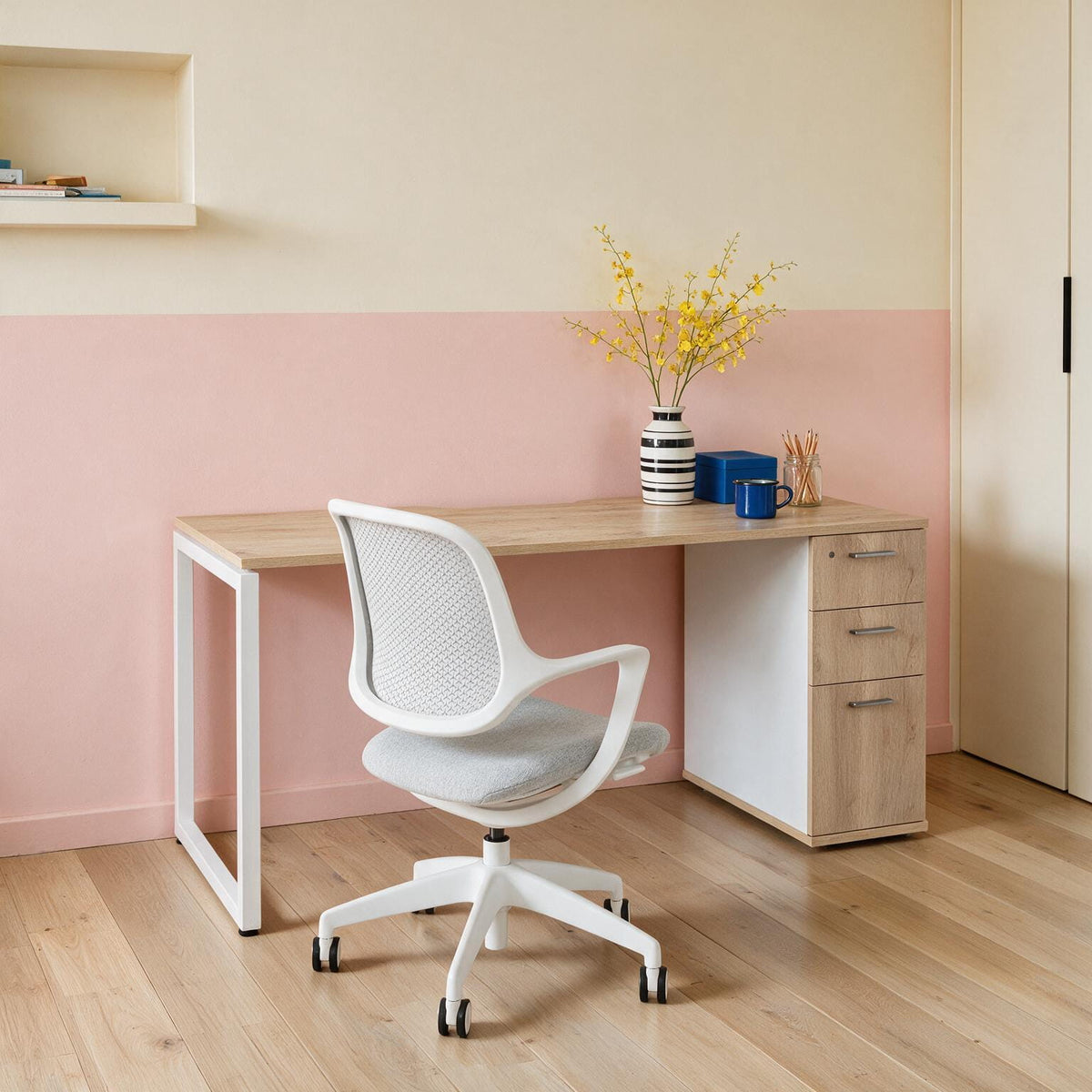 Barrel Oak home office desk with built-in drawers and a white frame, styled with an ergonomic task chair