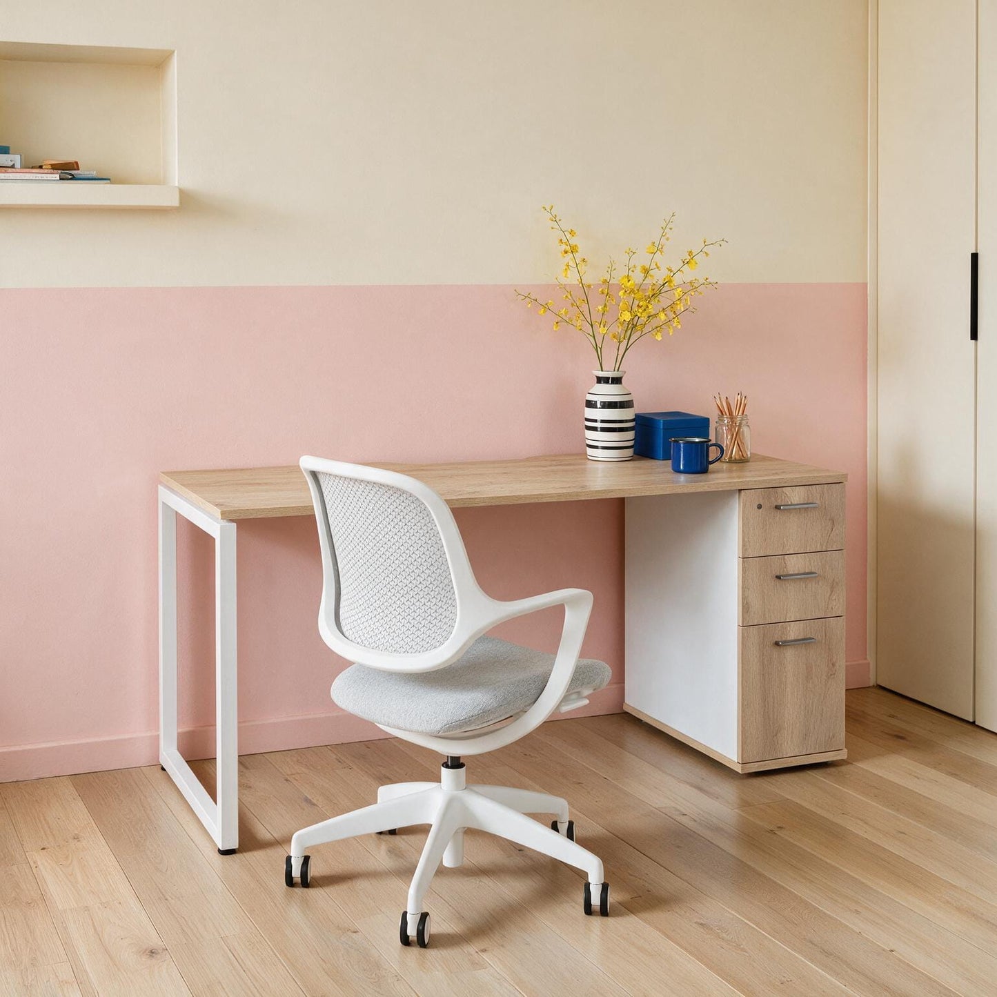 Barrel Oak home office desk with built-in drawers and a white frame, styled with an ergonomic task chair