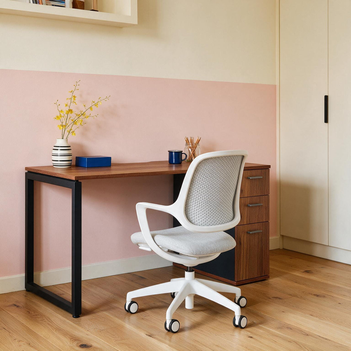 Leander-top home office desk with built-in drawers and a black frame, shown with a task chair