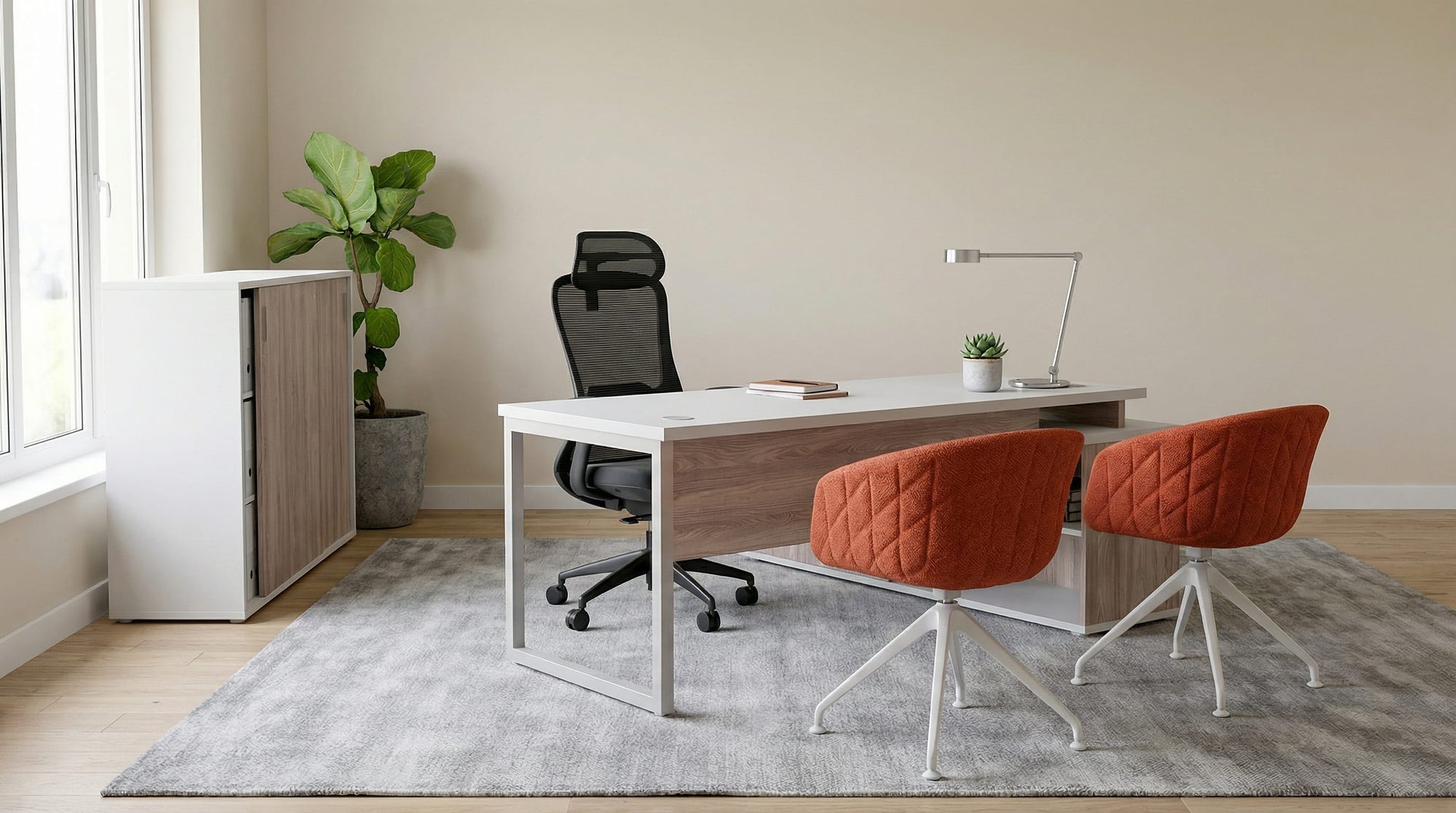 Modern office space with managers desk with a ergonomic chair and two visitors chairs 