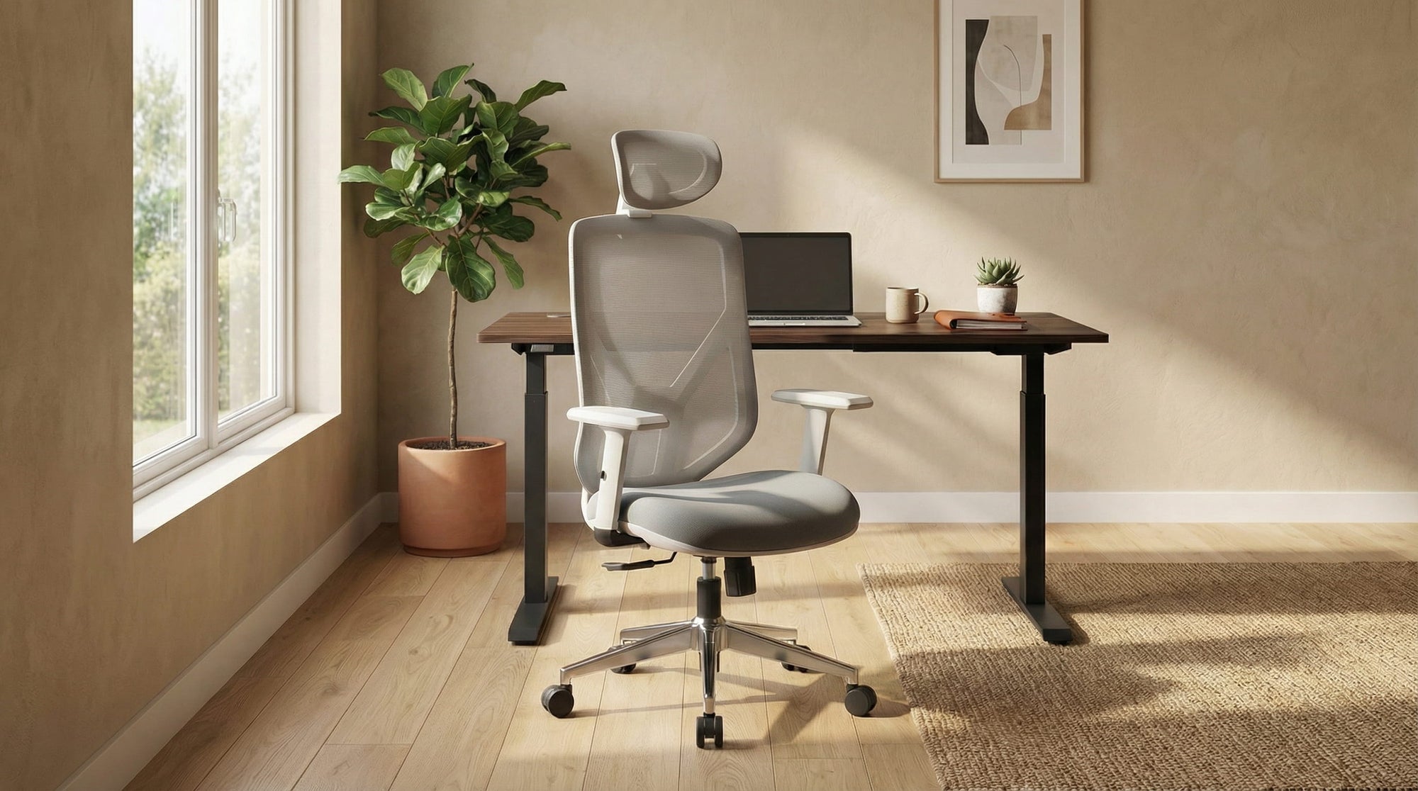 Modern office space with grey ergonomic office chair with height adjustable desk in a home office 