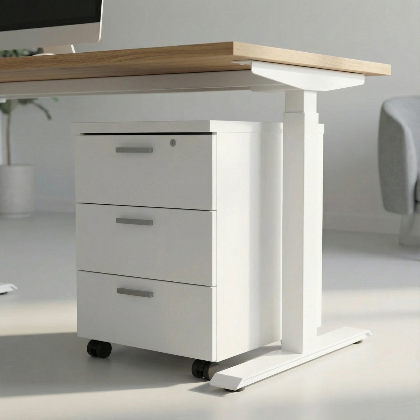 white storage with three drawers on wheels under a white framed sit stand height adjustable desk in a modern office room