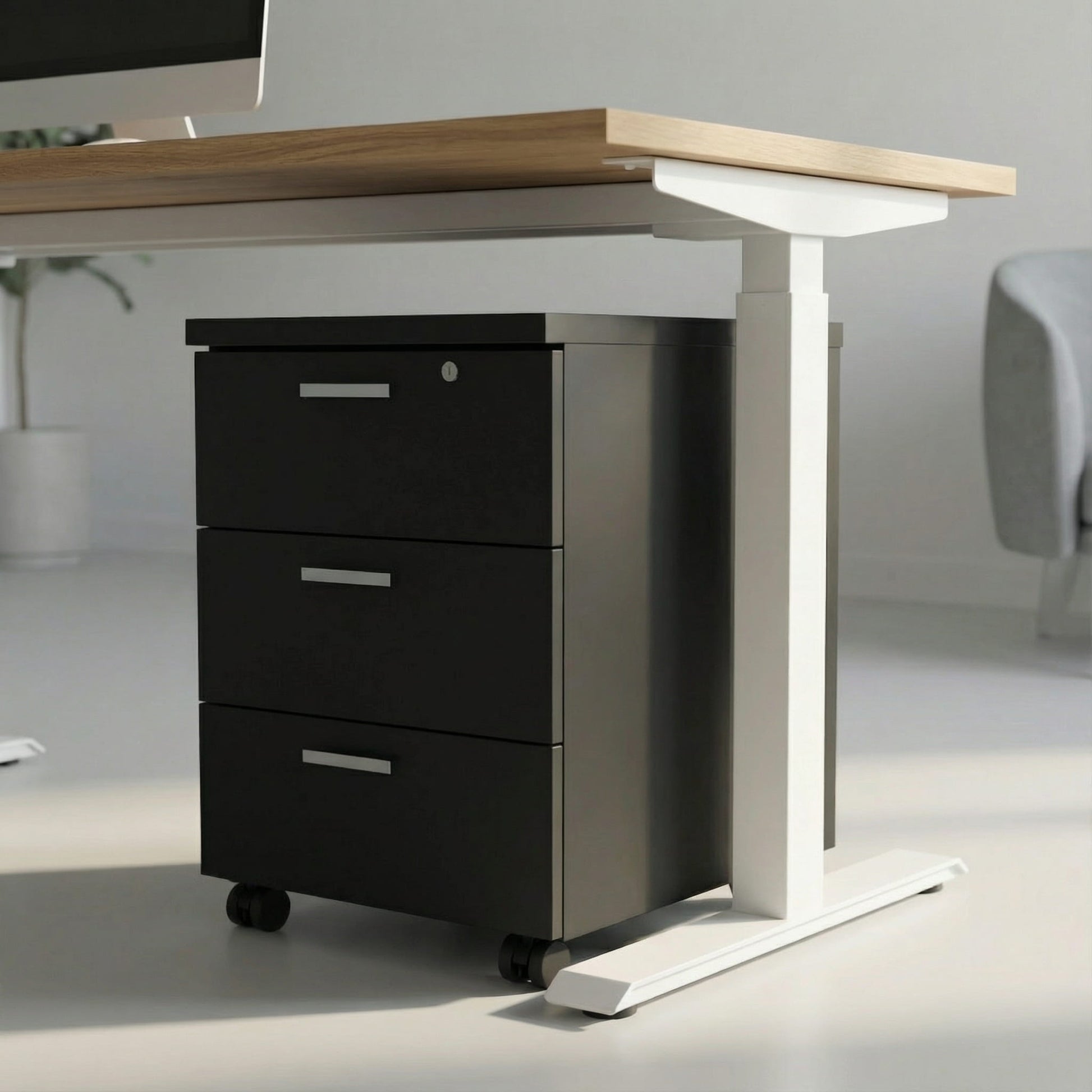 black storage with three drawers on wheels under a white framed sit stand height adjustable desk in a modern office room