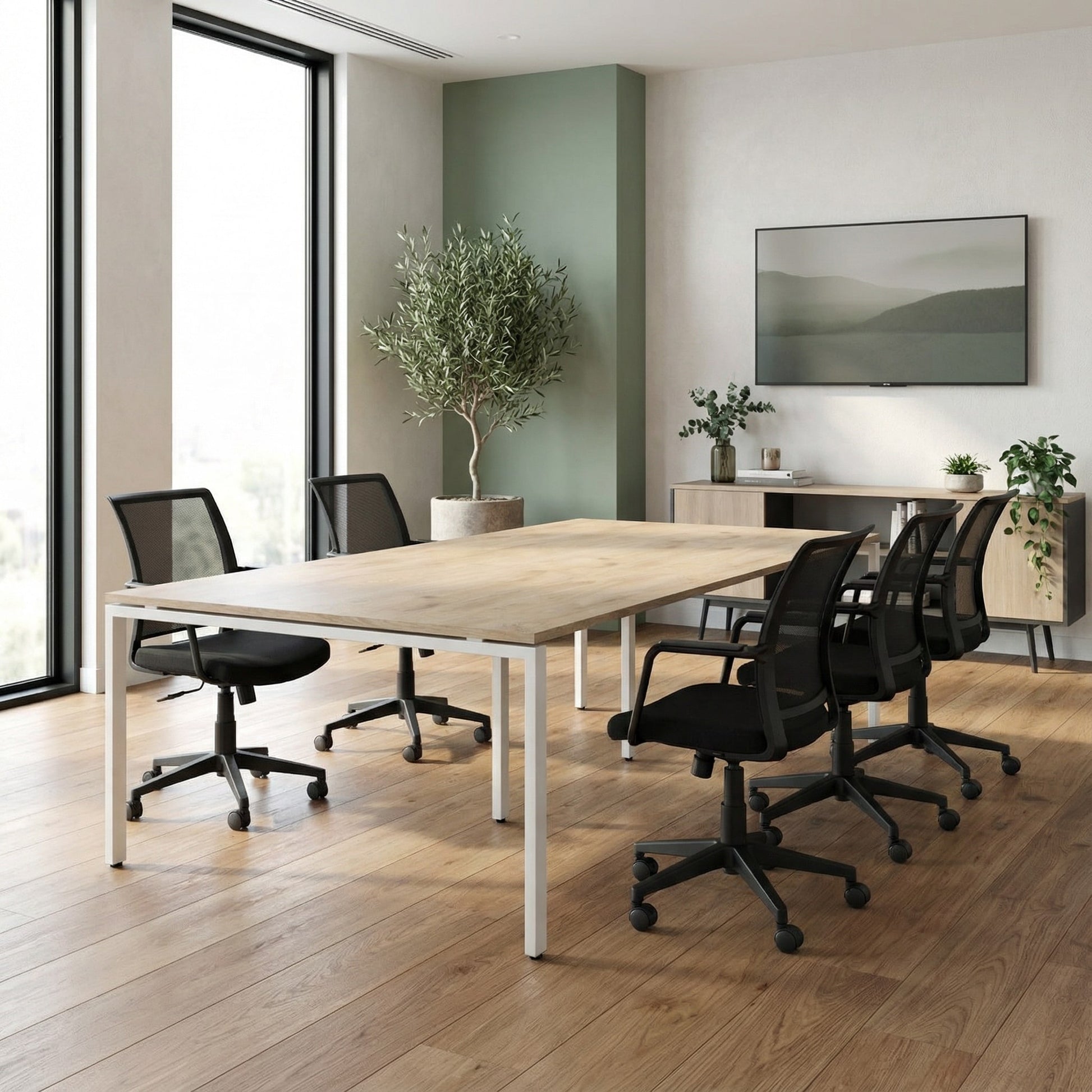 Modern office conference room with a large wooden table and black chairs.