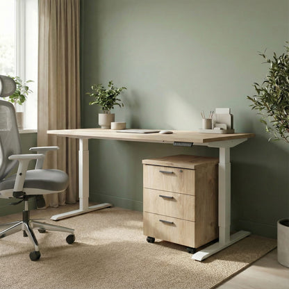 Oak storage with three drawers on wheels under a white framed sit stand height adjustable desk in a modern office room with a grey ergonomic chair