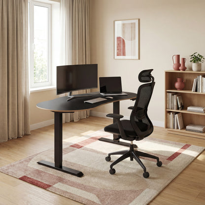 Modern home office with a height adjustable desk, ergonomic office chair, and computer setup.
