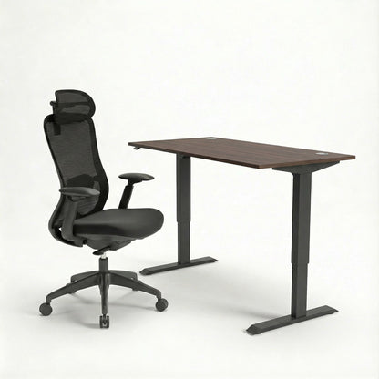 Black ergonomic office chair and adjustable sit stand desk on a white background