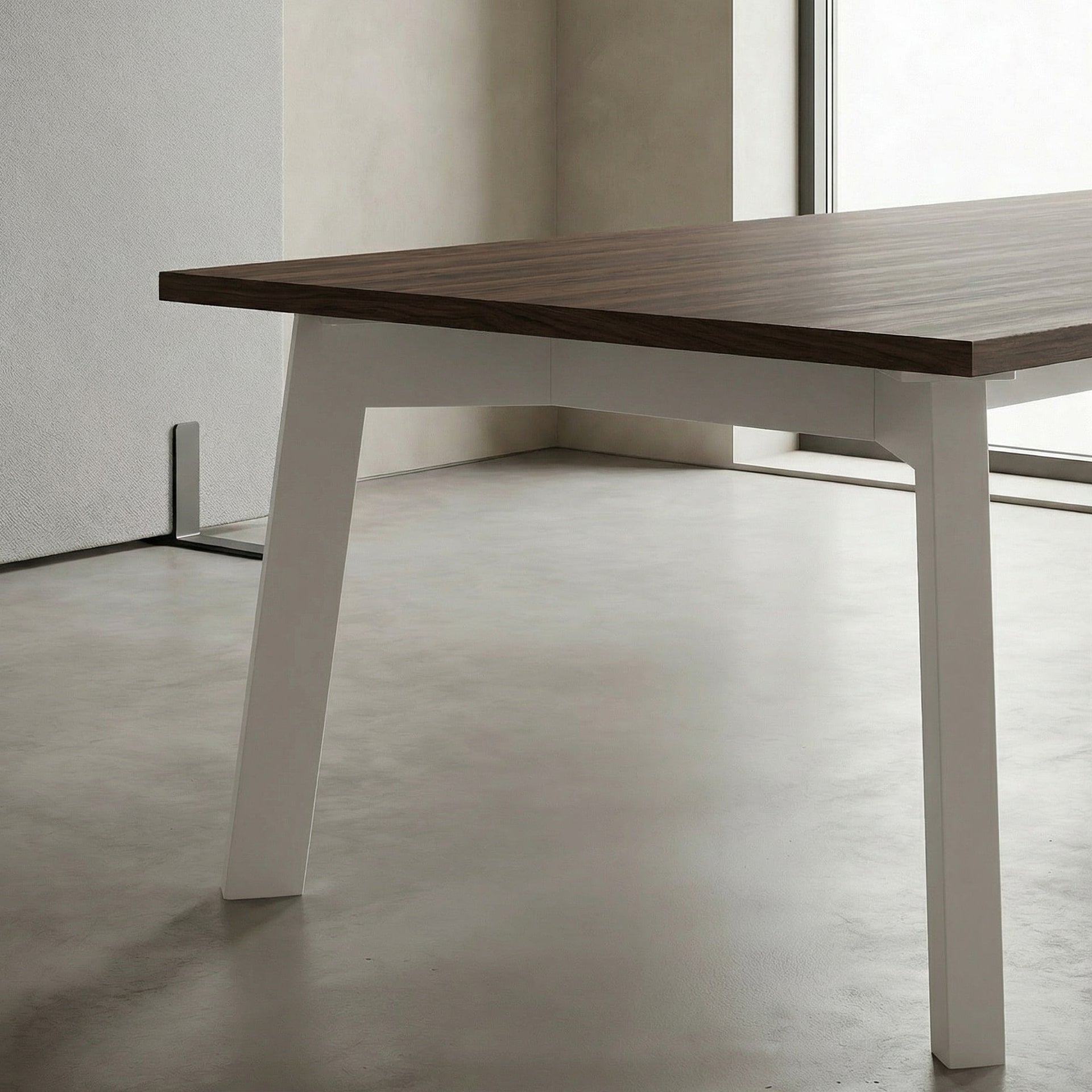 Wooden boardroom table with white legs in a minimalistic room