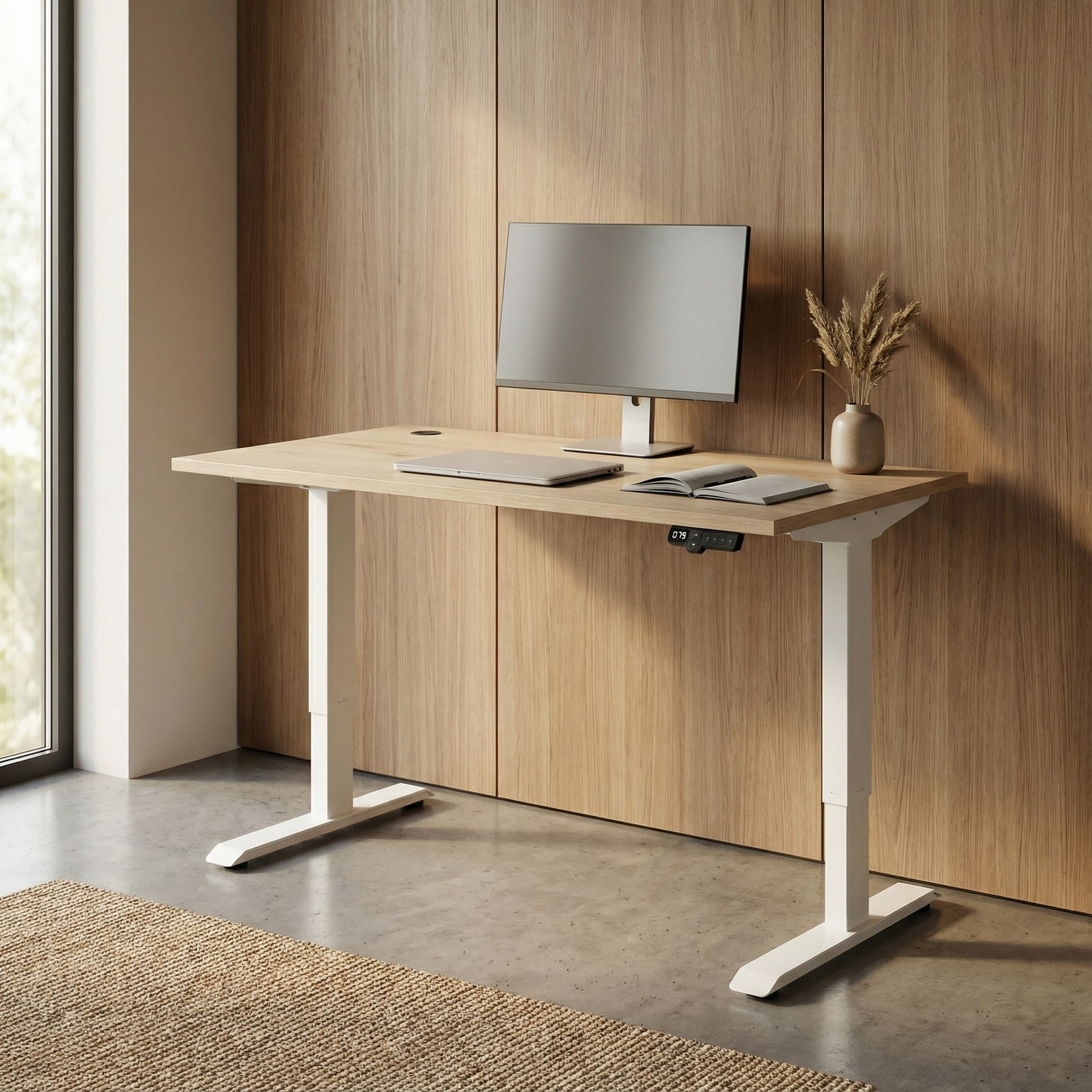 Modern adjustable desk with a computer setup in a room with wooden walls.
